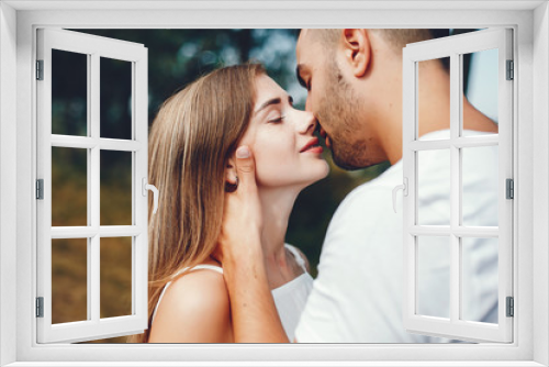 Beautiful couple spend time in a summer park