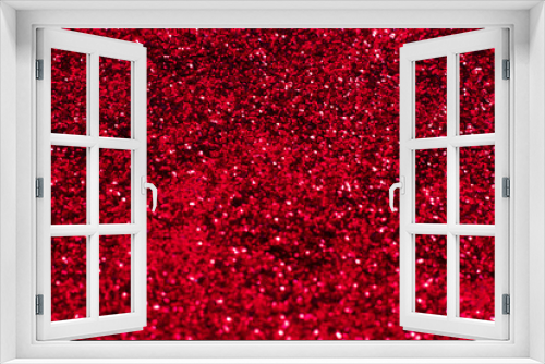 Red glitter texture. Festive sparkling sequins background closeup. Wpaper for Valentine, New Year or Christmas Holidays.