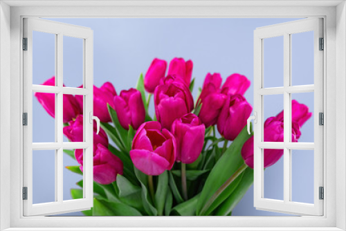 Fototapeta Naklejka Na Ścianę Okno 3D - Bouquet of pink tulips on a blue background.