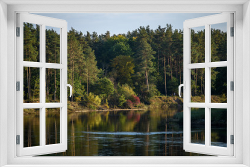 Fototapeta Naklejka Na Ścianę Okno 3D - calm lake in bright sun light with reflections of clouds and trees and blue sky