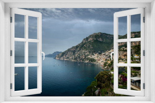 Fototapeta Naklejka Na Ścianę Okno 3D - looking back at Amalfi on the Amalfi coast in Italy showing the buildings and house as the rise up the hill with the harbour, blue sea and hills