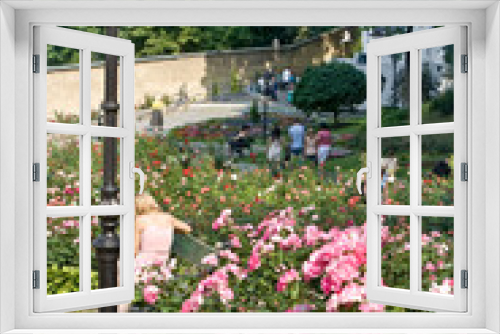 Fototapeta Naklejka Na Ścianę Okno 3D - People relax in the rose garden