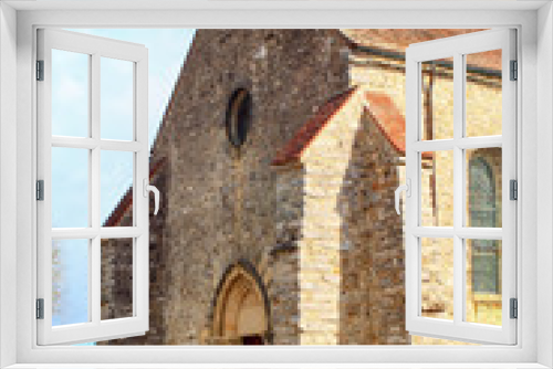Fototapeta Naklejka Na Ścianę Okno 3D - Medieval church in pale stone with carved gothic style porch View of a place of Christian religious worship in the countryside