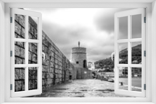 Fototapeta Naklejka Na Ścianę Okno 3D - View of the watchtower over the sea in the town of Recco, Genoa. Black and white