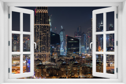 Fototapeta Naklejka Na Ścianę Okno 3D - Colourful night time view of downtown Dubai