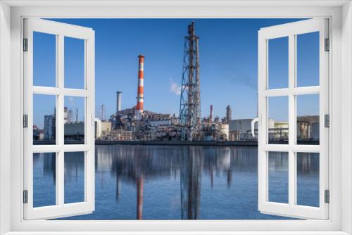 Fototapeta Naklejka Na Ścianę Okno 3D - Atmosphere of a heavy industrial factory by the sea in the industrial area