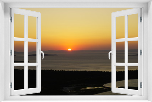 Fototapeta Naklejka Na Ścianę Okno 3D - Blazing sunset over Aegean Sea (Ege Denizi) in Seytan Sofrasi (Devil's Table), Ayvalik, Turkey. Bright dramatic sky, dark ground. Scenic colorful sky at sunset landscape. Sun over skyline, horizon.