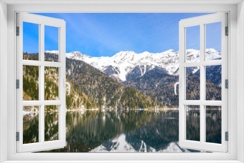 Fototapeta Naklejka Na Ścianę Okno 3D - Beautiful mountain lake in the spring. In the background, mountains covered with snow are reflected in the waters of the lake.