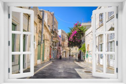 Fototapeta Naklejka Na Ścianę Okno 3D - Sidewalk with traditional neoclassical buildings in Ermoupoli in Syros island capital of Cyclades Greece