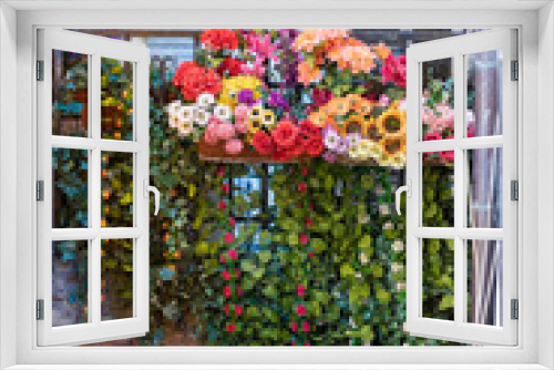 Fototapeta Naklejka Na Ścianę Okno 3D - Montepulciano, Italy town village city in Tuscany closeup of window balcony and colorful flower decorations on sunny summer day nobody architecture hanging vine green plant
