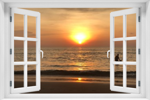 Fototapeta Naklejka Na Ścianę Okno 3D - the sun sets on the horizon where the sea joins the sky. people-adult and child-swim in the sea and enjoy the Golden sunset on the beach