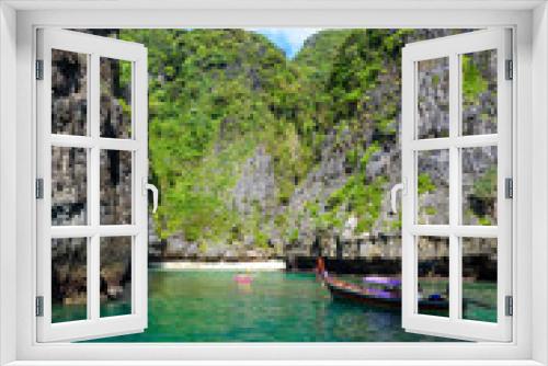 Fototapeta Naklejka Na Ścianę Okno 3D - Wang Long Bay with crystal turquoise water, Tropical island Koh Phi Phi Don, Krabi Province, Thailand - Long boat in beautiful lagoon with rocks covered with a plants