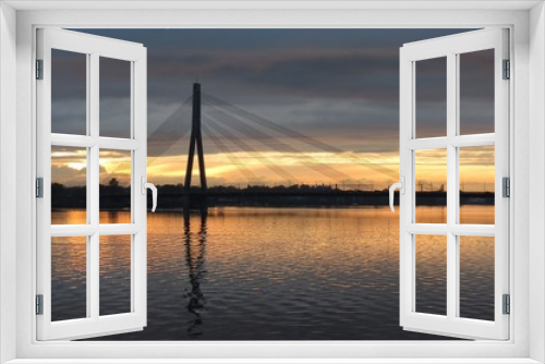 Fototapeta Naklejka Na Ścianę Okno 3D - The cable-stayed bridge across the Daugava River in Riga during sunset