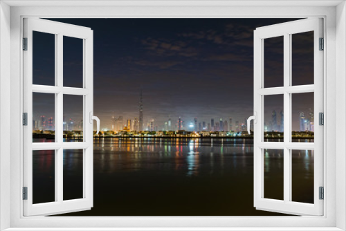 Fototapeta Naklejka Na Ścianę Okno 3D - Night or dusk in Dubai. Dawn over Burj Khalifa. Nightly Dubai downtown. View from sea to Dubai quay