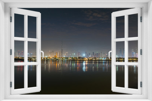 Fototapeta Naklejka Na Ścianę Okno 3D - Dubai in night city lights or dusk. Dawn over Burj Khalifa. Nightly Dubai downtown. View from sea to Dubai quay