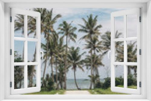 Fototapeta Naklejka Na Ścianę Okno 3D - white road to the ocean with palm trees
