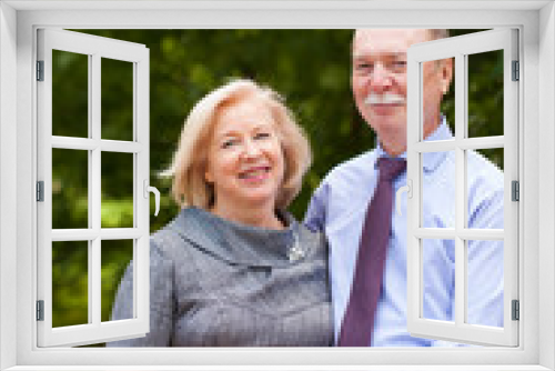 Senior couple walking in summer in park