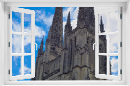 Cathedral of Saint-André overhanged by a dramatic blue sky, place Pey-Berland, Bordeaux, France