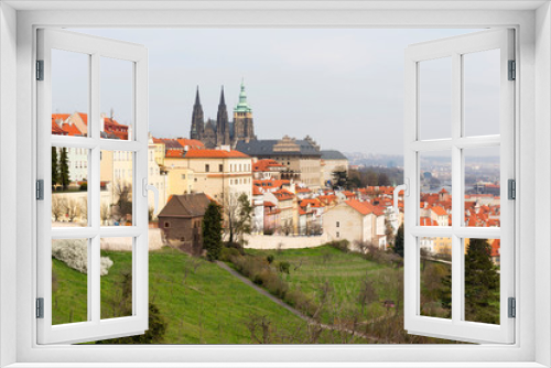 Fototapeta Naklejka Na Ścianę Okno 3D - Early spring Prague City with gothic Castle and the green Nature and flowering Trees, Czech Republic
