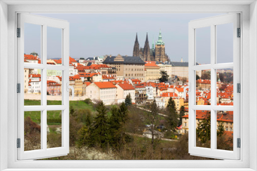 Fototapeta Naklejka Na Ścianę Okno 3D - Early spring Prague City with gothic Castle and the green Nature and flowering Trees, Czech Republic