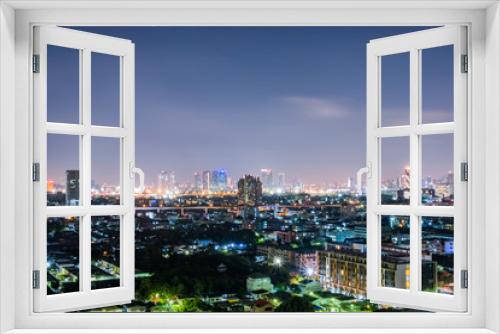 Fototapeta Naklejka Na Ścianę Okno 3D - Cityscape from high rise building at night with skyline and clouds. skyscraper in metropolis town with beautiful neon light Bangkok Thailand.