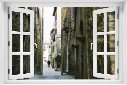 Fototapeta Naklejka Na Ścianę Okno 3D - Narrow street on a medieval town in Tuscany