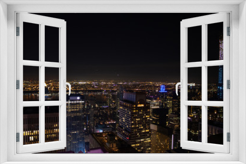 Fototapeta Naklejka Na Ścianę Okno 3D - Night time aerial view of Manhattan in New York City showing the classic high rise buildings and city scape in the USA