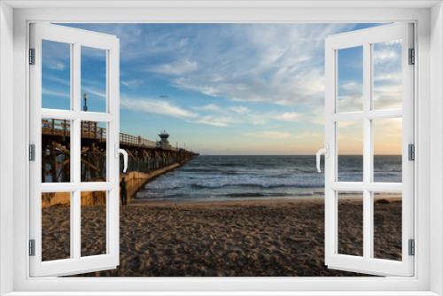 Fototapeta Naklejka Na Ścianę Okno 3D - Sunset over an ocean pier on the west coast