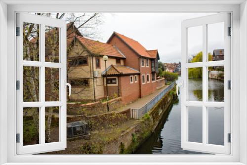 Fototapeta Naklejka Na Ścianę Okno 3D - Expensive waterside apartments and penthouses on the quayside of the River Wensum in the city of Norwich, Norfolk