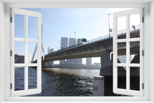 Fototapeta Naklejka Na Ścianę Okno 3D - a journey to discover the modern and futuristic architectural city of Rotterdam, between bridges and skyscrapers