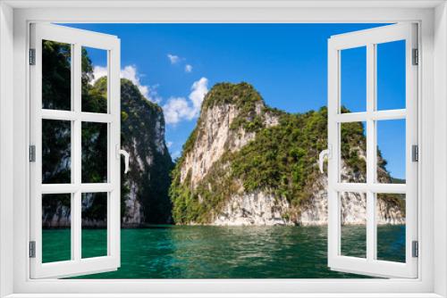 Fototapeta Naklejka Na Ścianę Okno 3D - Beautiful nature rock mountains cliff and blue emerald water color lake river with blue clear sky in Ratchaprapa Dam at Khao Sok National Park, Surat Thani Province, Thailand. Asia tourism location.