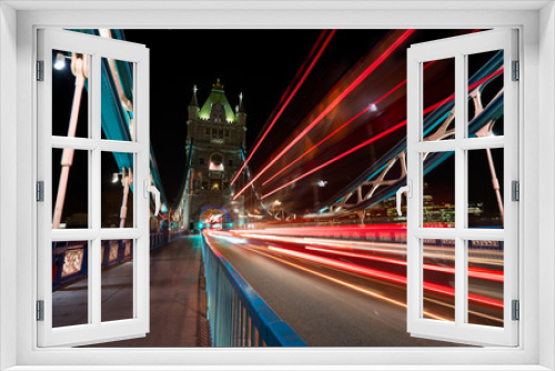 Fototapeta Naklejka Na Ścianę Okno 3D - Light trails produced by busses and cars on the Tower Bridge in London.