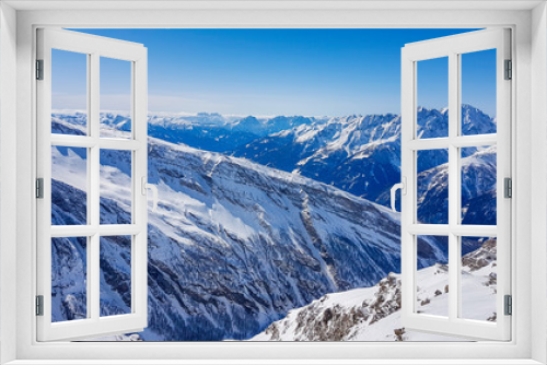 Fototapeta Naklejka Na Ścianę Okno 3D - A beautiful and serene landscape of mountains covered with snow. Thick snow covers the slopes. Clear weather. Sharp slopes of the mountains covered with snow, with partially visible rocks.