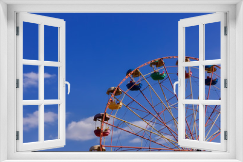 Fototapeta Naklejka Na Ścianę Okno 3D - Ferris wheel in the park against blue sky.