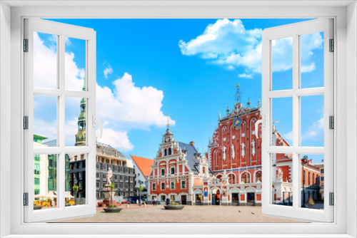 Fototapeta Naklejka Na Ścianę Okno 3D - View of the Old Town Ratslaukums square, Roland Statue, The Blackheads House near St Peters Cathedral against blue sky in Riga, Latvia. Summer sunny day