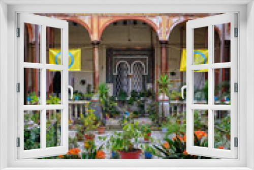 Fototapeta Naklejka Na Ścianę Okno 3D - April 2019 - Seville neighborhood courtyard with columns, garden plants in historical house of Andalusia - Spain.