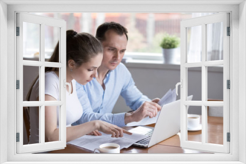 Millennial couple studying contract for new house before signing