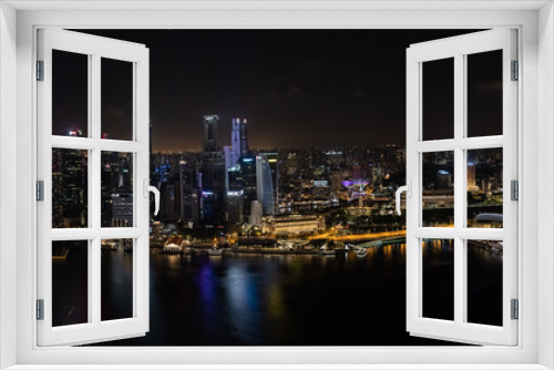 Fototapeta Naklejka Na Ścianę Okno 3D - Singapore - January 2019: Aerial night panorama of a Singapore's business district and Marina Bay