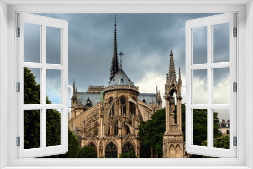 Fototapeta Naklejka Na Ścianę Okno 3D - Notre-Dame de Paris cathedral under cloudy sky.