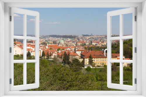 Fototapeta Naklejka Na Ścianę Okno 3D - Spring Prague City with St. Nicholas' Cathedral and the green Nature and flowering Trees, Czech Republic