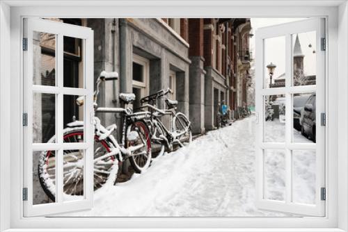 Fototapeta Naklejka Na Ścianę Okno 3D - Snow-covered streets in Amsterdam during a cold winter in the Netherlands.