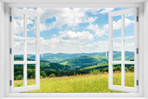 Fototapeta Naklejka Na Ścianę Okno 3D - beautiful summer countryside in mountains. wonderful sunny day scenery. grassy rural fields and meadows with wild herbs. hills and mountains in the distance. blue sky with fluffy clouds