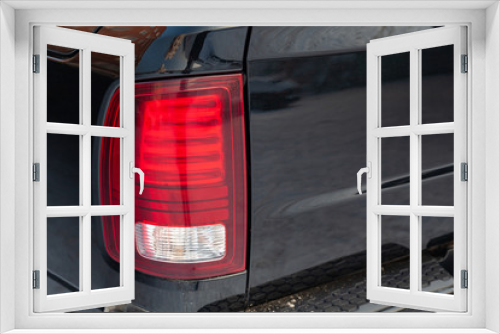 Fototapeta Naklejka Na Ścianę Okno 3D - Close-up on the rear LED brake light of red color on a black car in the back of a suv after cleaning, polishing and detailing. Auto service industry. Stop concept.
