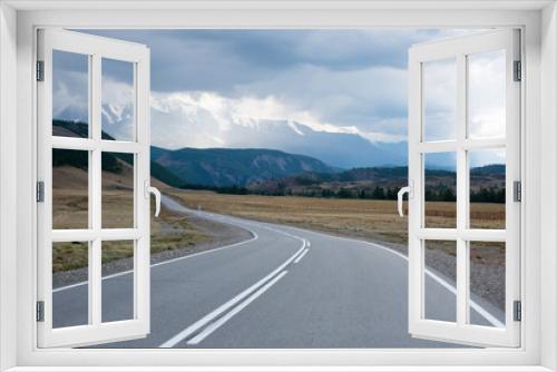 Fototapeta Naklejka Na Ścianę Okno 3D - Asphalt winding road in the mountainous area Altai in the summer and sky with clouds