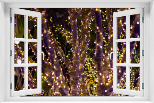 Fototapeta Naklejka Na Ścianę Okno 3D - Decorative outdoor string lights hanging on tree in the garden at night time festivals season - decorative Christmas lights - happy new year 