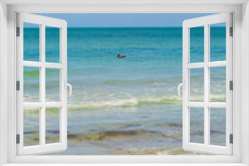 Fototapeta Naklejka Na Ścianę Okno 3D - Looking out to sea from Redington Shores in Florida, with a pelican on the water in the distance