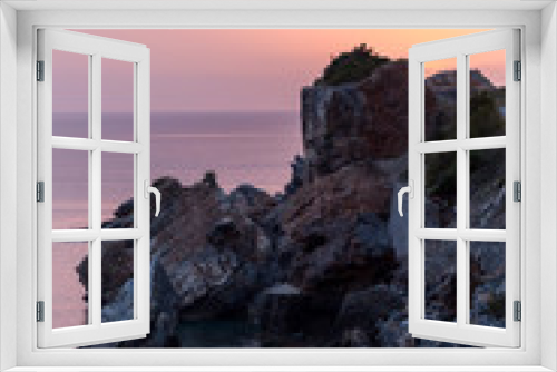 Fototapeta Naklejka Na Ścianę Okno 3D - Sunset by the sea. Vertical shot of the sea and rocks.