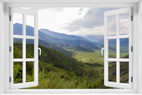 Altai Mountain valley with white clouds. Summer time. Mountain car pass.