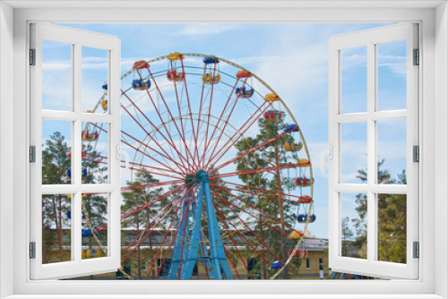 Fototapeta Naklejka Na Ścianę Okno 3D - Childrens carousel ferris wheel for riding in amusement park.