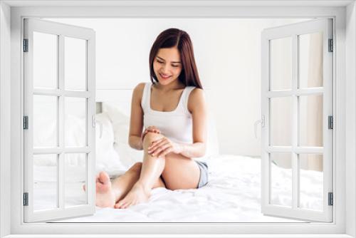 Beautiful woman beauty health care.beauty and spa.perfect fresh skin.Woman applying moisturizing cream on long legs at home